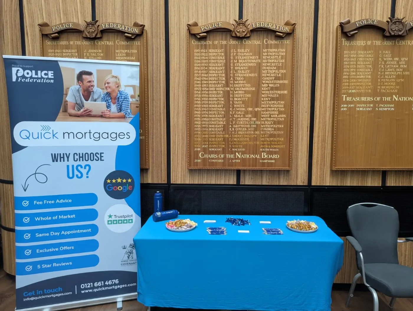 A Quick Mortgages stand set up beside the honours boards at a Police Federation building