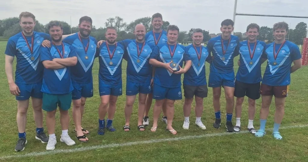 A police rugby team lined up with their medals after a win